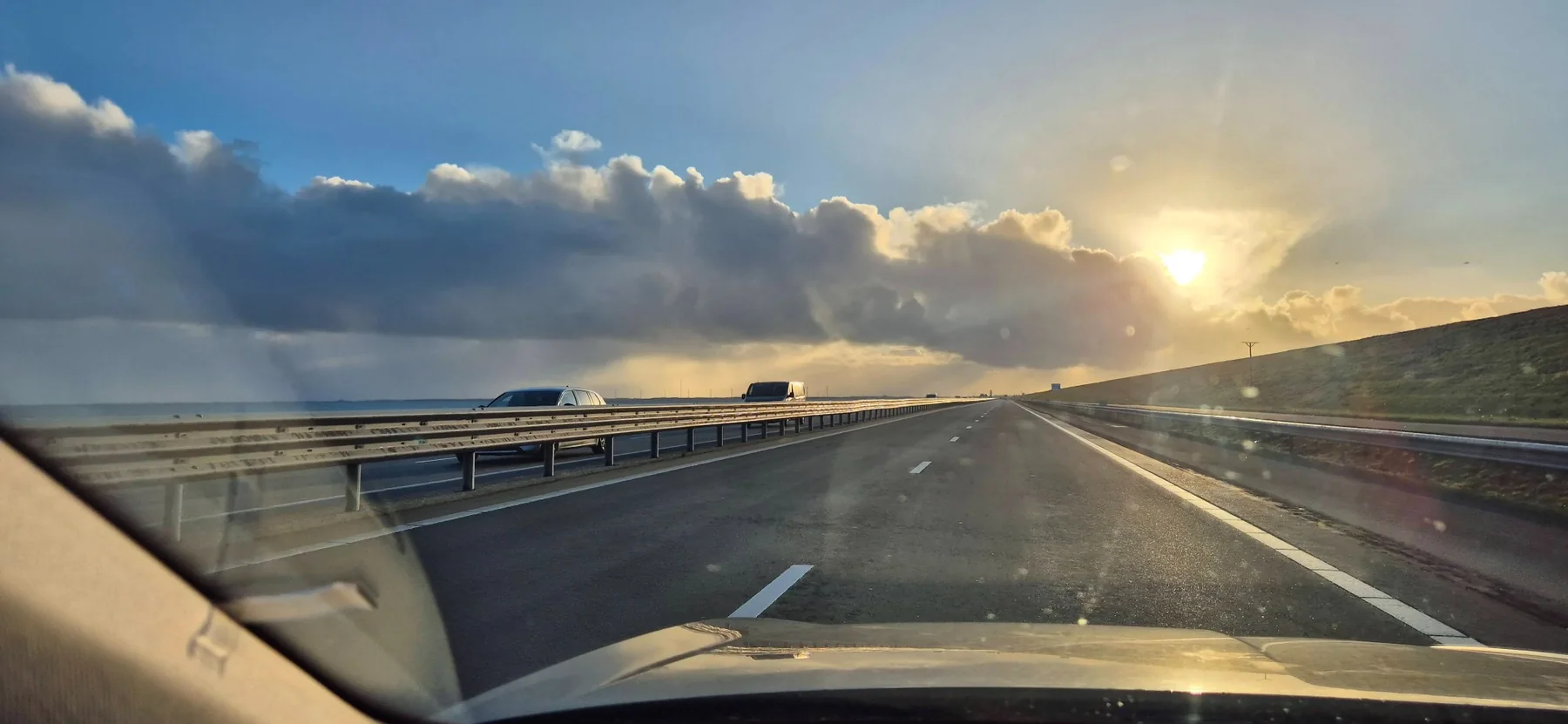 Road trip at sunset, photographed from inside a car